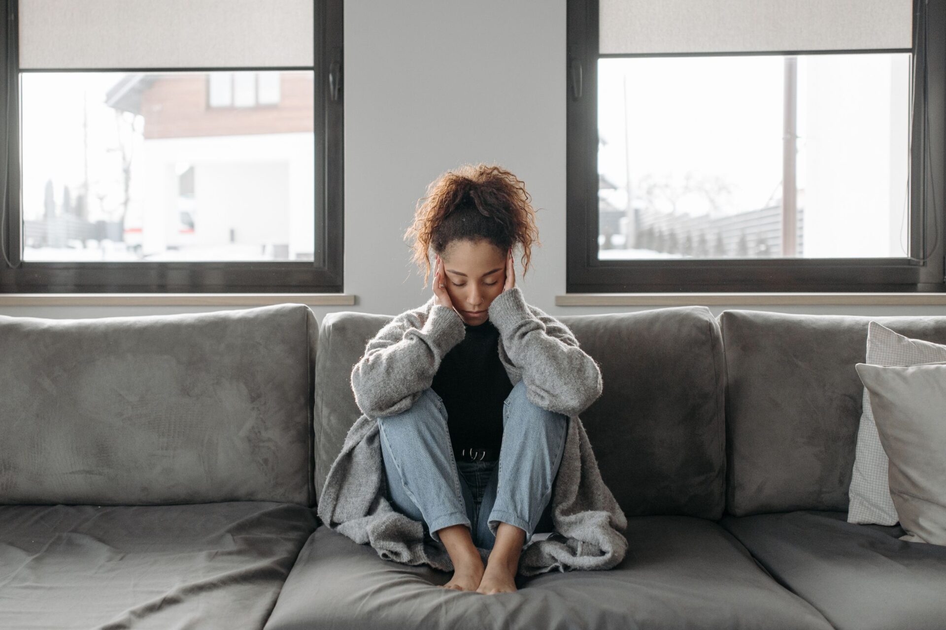 woman sitting on the dealing with Seizures From Alcohol Withdrawal