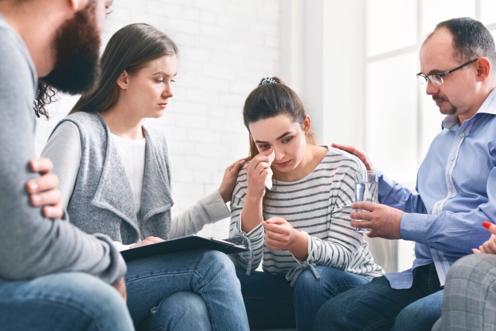 woman sitting in group with other patients discussing how long does cocaine stay in your system?