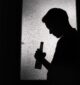 man standing in the dark wondering how long does it take to get addicted to alcohol