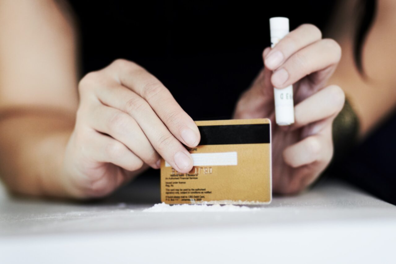 woman spreading out lines of cocaine thinking to herself why is cocaine so addictive