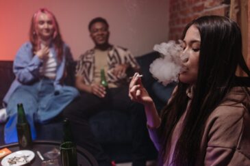 people in a group smoking marijuana asking can weed be laced with fentanyl