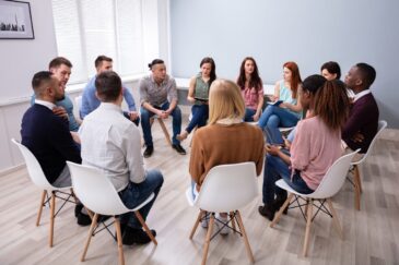 patients sitting in group therapy discussing the difference between php vs iop